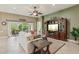 Bright living room with a TV, open access to other rooms, and natural light at 1304 Zombar Pl, The Villages, FL 32163
