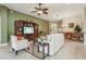Cozy living room with comfortable seating, a TV, and an open-concept layout at 1304 Zombar Pl, The Villages, FL 32163