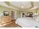 View of the main bedroom with hardwood floors, a tray ceiling, and ensuite bathroom at 1304 Zombar Pl, The Villages, FL 32163