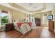 Spacious main bedroom with a tray ceiling, hardwood floors and lots of natural light at 1304 Zombar Pl, The Villages, FL 32163