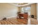 Office space featuring a wooden desk, parquet flooring, and a tray ceiling at 1304 Zombar Pl, The Villages, FL 32163