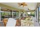 Relaxing screened patio with seating, ceiling fans, and sliding glass doors at 1304 Zombar Pl, The Villages, FL 32163