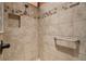 Tiled shower with a built-in niche and grab bar for safety at 1304 Zombar Pl, The Villages, FL 32163