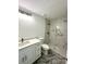 Bathroom with a walk-in shower with tile surround, modern vanity, and stylish fixtures at 13430 Sw 105Th Place, Dunnellon, FL 34432