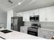 Modern kitchen featuring stainless steel appliances, pristine white cabinetry, and sleek countertops at 13430 Sw 105Th Place, Dunnellon, FL 34432