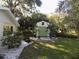 Well-maintained backyard with a storage shed, lush lawn, and decorative landscaping at 1485 Morningside Dr, Mount Dora, FL 32757