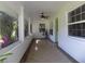 Bright and airy porch with tiled floor, lots of windows, and a ceiling fan at 1485 Morningside Dr, Mount Dora, FL 32757