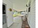 Side view of a carport entrance with brick steps, a black railing, and a sidewalk at 152 Dogwood Trl, Leesburg, FL 34748