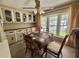 Bright dining area with a table, chairs, and built-in cabinets for ample storage at 152 Dogwood Trl, Leesburg, FL 34748