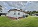 Exterior view of the property with green lawn and landscaping at 152 Dogwood Trl, Leesburg, FL 34748