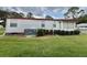 Exterior side view of a well-maintained single-story home at 152 Dogwood Trl, Leesburg, FL 34748