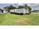 Well-kept home with lush green lawn and mature landscaping at 152 Dogwood Trl, Leesburg, FL 34748