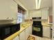 Efficient kitchen featuring white cabinets and modern appliances at 152 Dogwood Trl, Leesburg, FL 34748