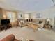 Inviting living room featuring a comfortable sectional sofa and neutral decor at 152 Dogwood Trl, Leesburg, FL 34748