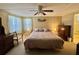 Relaxing main bedroom with a ceiling fan, soft lighting, neutral decor, and an ensuite bath at 152 Dogwood Trl, Leesburg, FL 34748