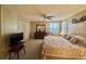 A well-lit main bedroom with a ceiling fan and two double closets at 152 Dogwood Trl, Leesburg, FL 34748