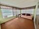 Cozy sun room with a comfortable couch, plenty of windows, and ample natural light at 152 Dogwood Trl, Leesburg, FL 34748