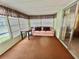 Relaxing sunroom with ample windows and comfortable seating area at 152 Dogwood Trl, Leesburg, FL 34748