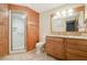 Bathroom with wood paneling, granite countertops, and glass door shower, providing a rustic design at 15935 J And J Dr, Tavares, FL 32778