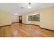 Light-filled living room with hardwood floors, a bay window and a glass paneled door at 15935 J And J Dr, Tavares, FL 32778