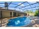 Inviting pool with an expansive screened-in lanai area, perfect for relaxing and entertaining outdoors at 15935 J And J Dr, Tavares, FL 32778