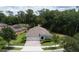 Aerial view of a well-maintained home with a manicured lawn and lush surrounding greenery at 179 Birchmont Dr, Deland, FL 32724