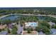 Beautiful aerial view showcases the community pool, lake, and surrounding lush greenery at 179 Birchmont Dr, Deland, FL 32724