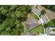Aerial perspective reveals a well-situated home with meticulously kept lawn, lush trees, and convenient road access at 179 Birchmont Dr, Deland, FL 32724