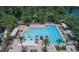 Stunning aerial view of the community pool, showcasing its ample seating, splash pad, and mature landscaping at 179 Birchmont Dr, Deland, FL 32724