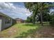 Spacious backyard, screened lanai, mature trees, and lush greenery at 179 Birchmont Dr, Deland, FL 32724