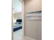 View into bedroom with ceiling fan, bed with blue bedding, and tiled floor at 179 Birchmont Dr, Deland, FL 32724