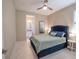 Comfortable bedroom features tile floors, ensuite bathroom, and stylish ceiling fan at 179 Birchmont Dr, Deland, FL 32724