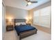 Neutral toned bedroom with a ceiling fan and natural lighting from a large window at 179 Birchmont Dr, Deland, FL 32724