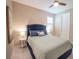Comfortable bedroom features a large window, tile floors, and a stylish ceiling fan at 179 Birchmont Dr, Deland, FL 32724