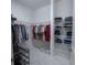 Walk-in closet with shelving and hanging racks for optimal storage at 179 Birchmont Dr, Deland, FL 32724
