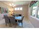 Inviting dining room with a stylish chandelier, large windows, and comfortable seating at 179 Birchmont Dr, Deland, FL 32724