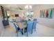 Open-concept dining area with modern decor, tile floors, and view into the living and kitchen areas at 179 Birchmont Dr, Deland, FL 32724