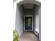 Inviting entryway with brick flooring and a stylish front door, leading into the home at 179 Birchmont Dr, Deland, FL 32724