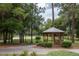 Picturesque gazebo nestled among trees in a common green area of the community at 179 Birchmont Dr, Deland, FL 32724