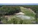 Scenic golf course view with lush green grass, trees, and a sand trap at 179 Birchmont Dr, Deland, FL 32724