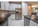 Updated kitchen featuring stainless steel appliances, granite counters, and white cabinets at 179 Birchmont Dr, Deland, FL 32724