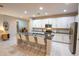 Kitchen with marble countertops, white cabinets, stainless steel appliances, and a spacious island with seating at 179 Birchmont Dr, Deland, FL 32724