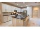 Modern kitchen with white cabinets, stainless steel appliances, and a sleek black countertop island at 179 Birchmont Dr, Deland, FL 32724