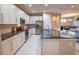 Modern kitchen with white cabinetry, dark countertops, stainless steel appliances, and a breakfast bar overlooking dining at 179 Birchmont Dr, Deland, FL 32724