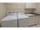 Bright laundry room with tile floors, modern washer and dryer, and utility sink at 179 Birchmont Dr, Deland, FL 32724