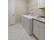 Well-lit laundry room with tile floors, modern washer and dryer, and utility sink at 179 Birchmont Dr, Deland, FL 32724