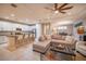 Bright living room with tile floors, modern white kitchen, and comfortable seating area at 179 Birchmont Dr, Deland, FL 32724