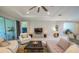 Bright living room with elegant furniture, a large ceiling fan, and access to outdoor living spaces at 179 Birchmont Dr, Deland, FL 32724