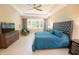 Spacious main bedroom featuring a ceiling fan, neutral walls, and ample natural light from large windows at 179 Birchmont Dr, Deland, FL 32724