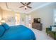 Bright main bedroom featuring a ceiling fan, television, and tiled floors at 179 Birchmont Dr, Deland, FL 32724